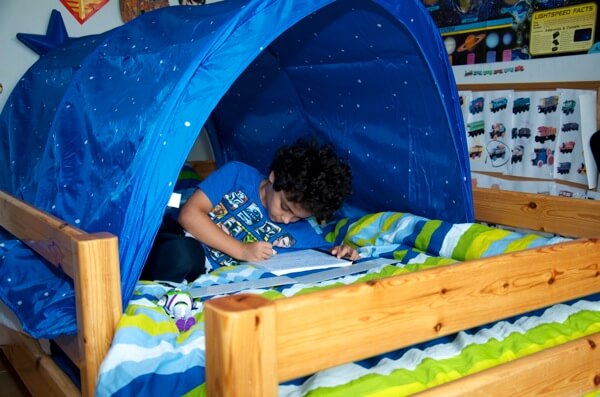 Writing inside his brand new tent
